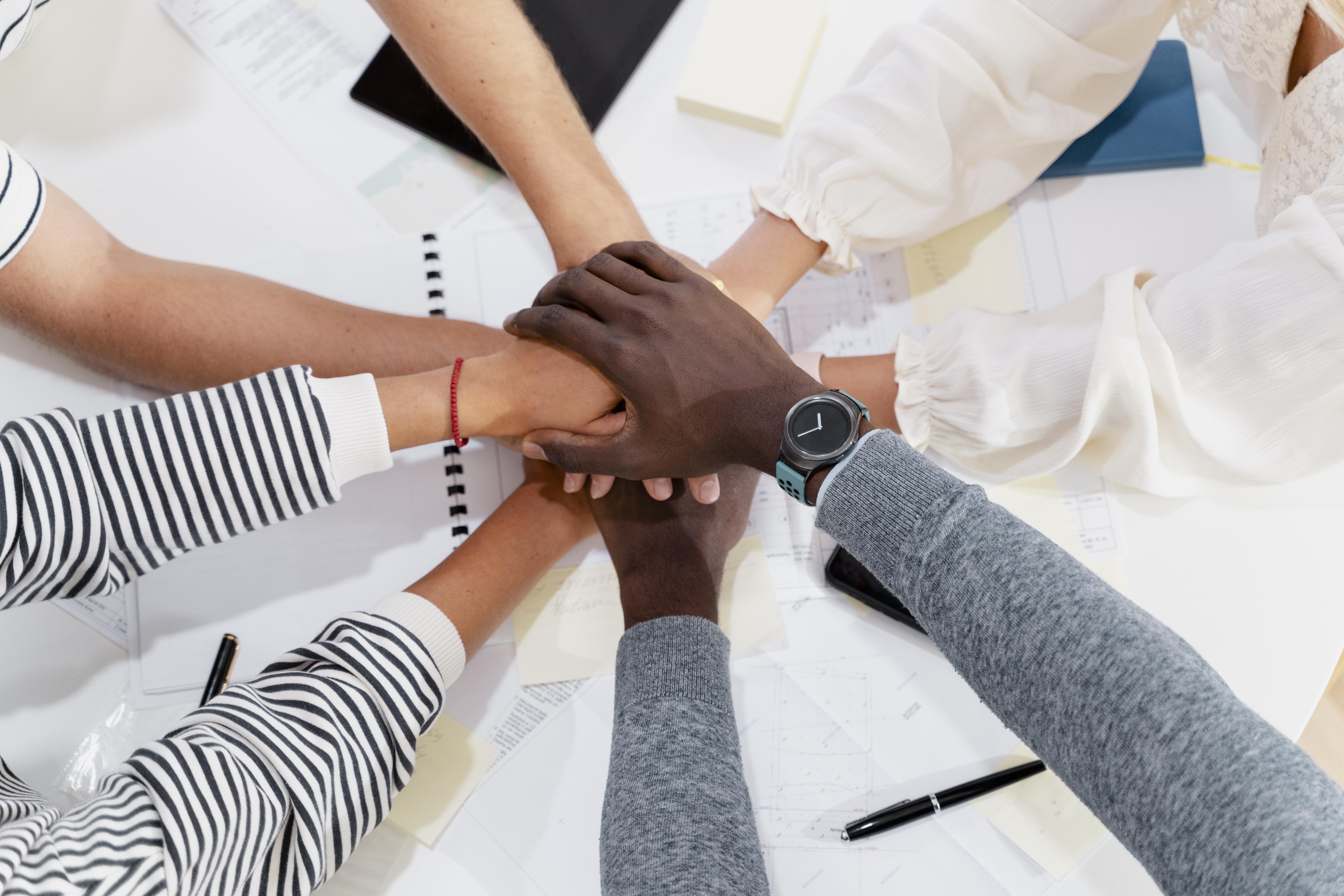 close-up-young-colleagues-hands-meeting